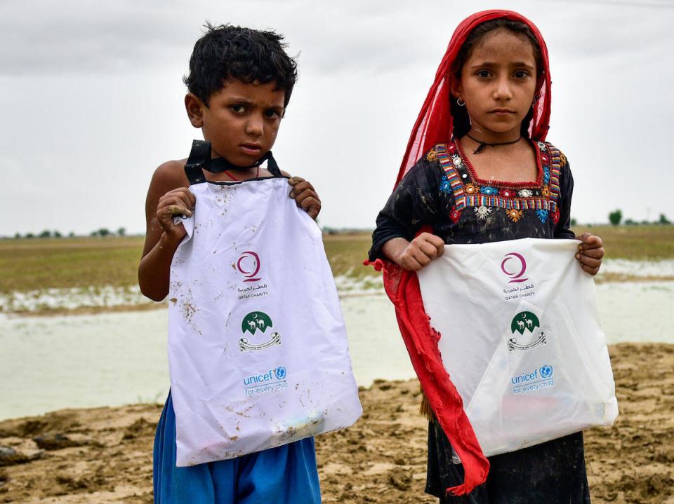Children in Naseerabad district, Balochistan province, Pakistan, hold UNICEF hygiene kits distributed after flash floods caused by heavy monsoon rains devastated remote rural communities. 