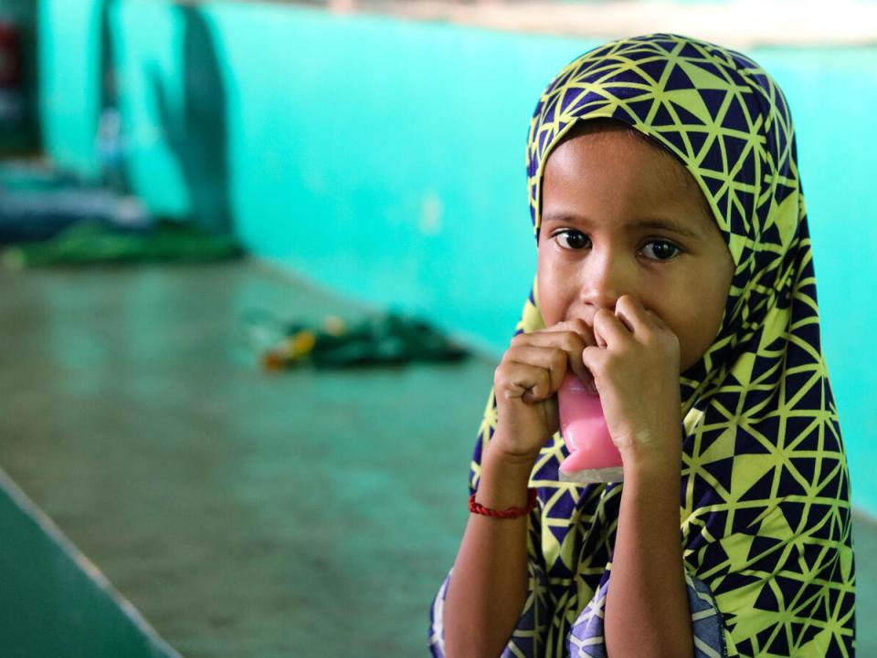 Bainor, 6, eats a snack inside a gymnasium serving as an evacuation center for children and families displaced by Severe Tropical Storm Nalgae in Parang municipality, Maguindanao province, in Southern Philippines. 