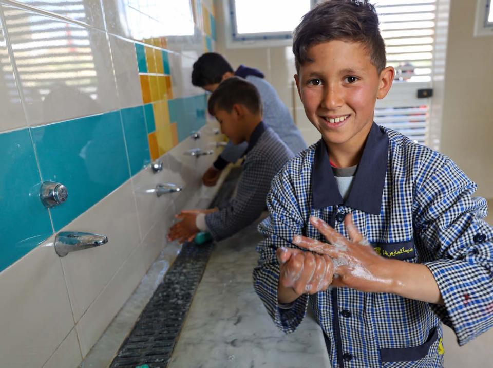 Students wash their hands in the new UNICEF-sponsored sanitary block at Mars Elementary School in Kesra, Tunisia.