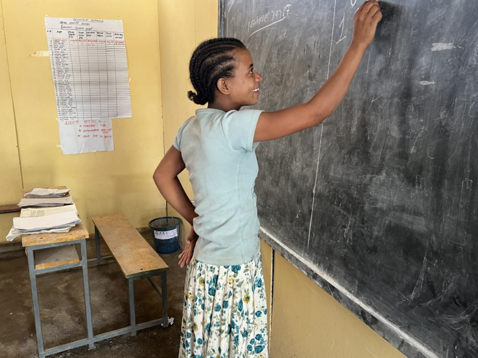 Thirteen-year-old Emyte writes her class assignment on the blackboard in Ethiopia's Amhara Region. 