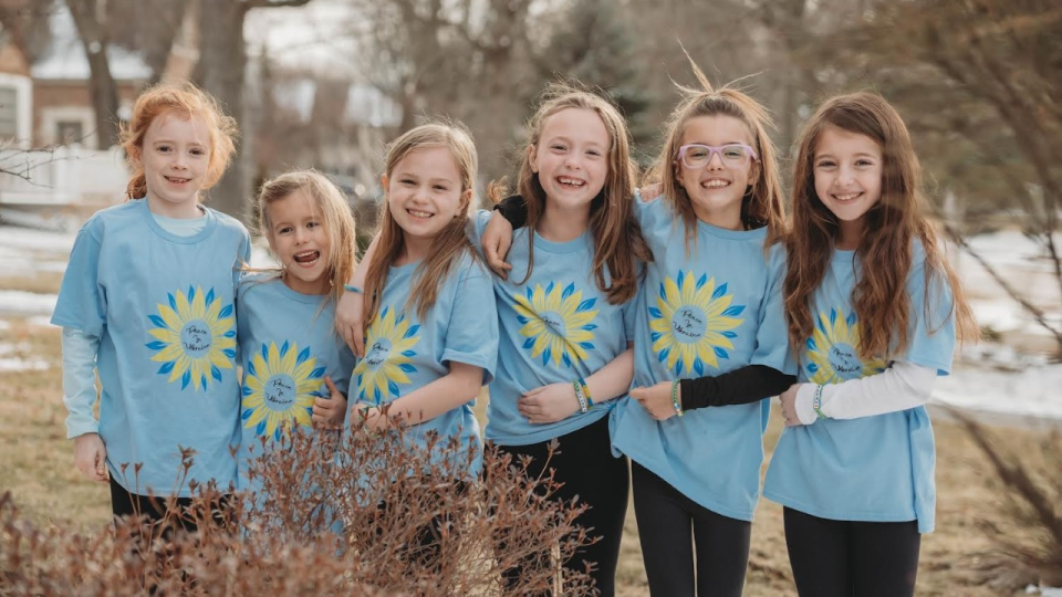 In Clarendon Hills, Illinois, the Giving Girls, a group of second-graders, show off some of the homemade bracelets they made to raise money to support UNICEF's work to help children caught up in the war in Ukraine. 