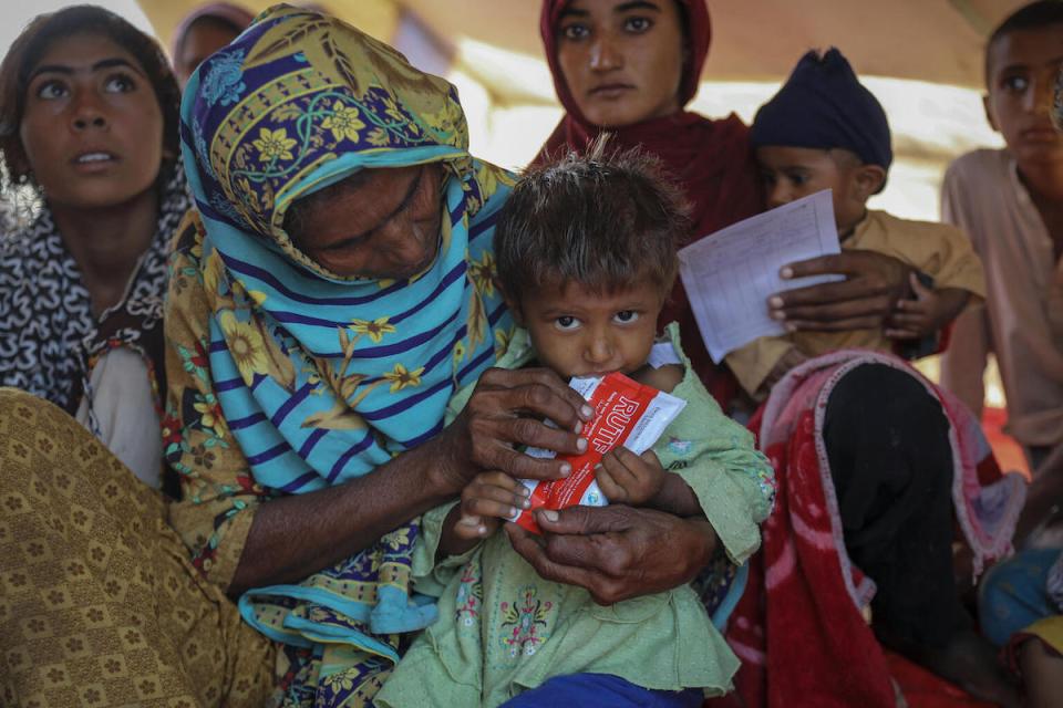 A child suffering from severe acute malnutrition is given Ready-to-Use Therapeutic Food at a UNICEF-supported camp in Sindh province, Pakistan, where families displaced by catastrophic flooding are receiving emergency assistance..
