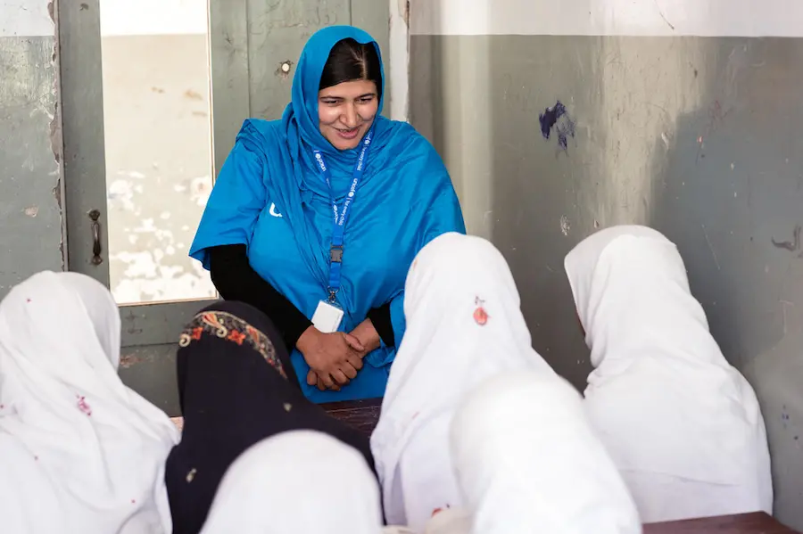 UNICEF Education Specialist Anita Haidary meets with students at a UNICEF-supported school in Nangarhar, Afghanistan in 2019. UNICEF Education Specialist Anita Haidary meets with students at a UNICEF-supported school in Nangarhar, Afghanistan in 2019.