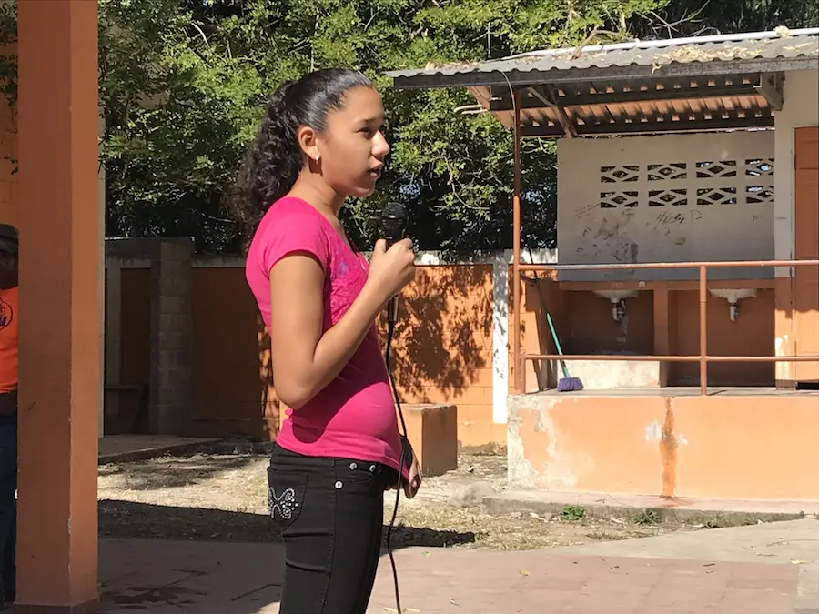 Girl Speaking into Microphone