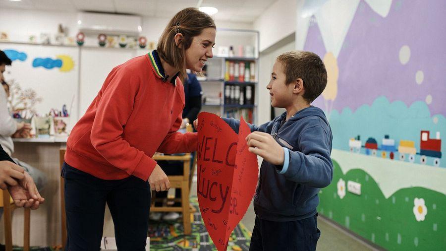 Lucy Meyer, spokesperson for the UNICEF-Special Olympics partnership, receives a warm welcome from a student during her visit to a school in Montenegro.