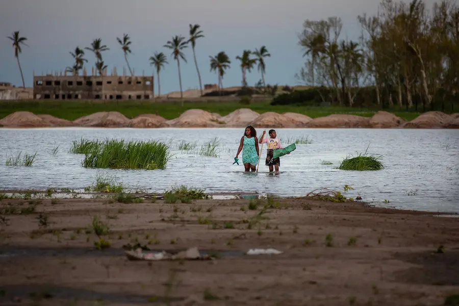 A woman and child walk through a flooded area of Sofala province outside the port city of Beira, Mozambique where Cyclone Eloise made landfall on Jan. 23, displacing thousands. A woman and child walk through a flooded area of Sofala province outside the port city of Beira, Mozambique where Cyclone Eloise made landfall on Jan. 23, displacing thousands.
