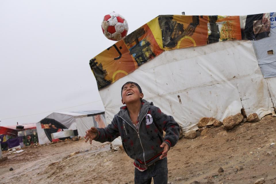 Abdel-Hamid, 7, a Syrian refugee, plays with a football outside his family’s tent shelter, in the Tal Al Abiad informal settlement in Baalbek, a town in the Bekaa Valley.