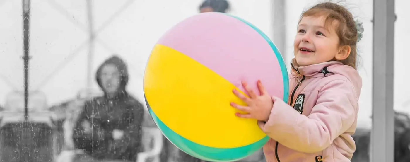 A child plays with a ball in a safe space at a UNICEF-UNHCR Blue Dot service center for Ukrainian refugees.