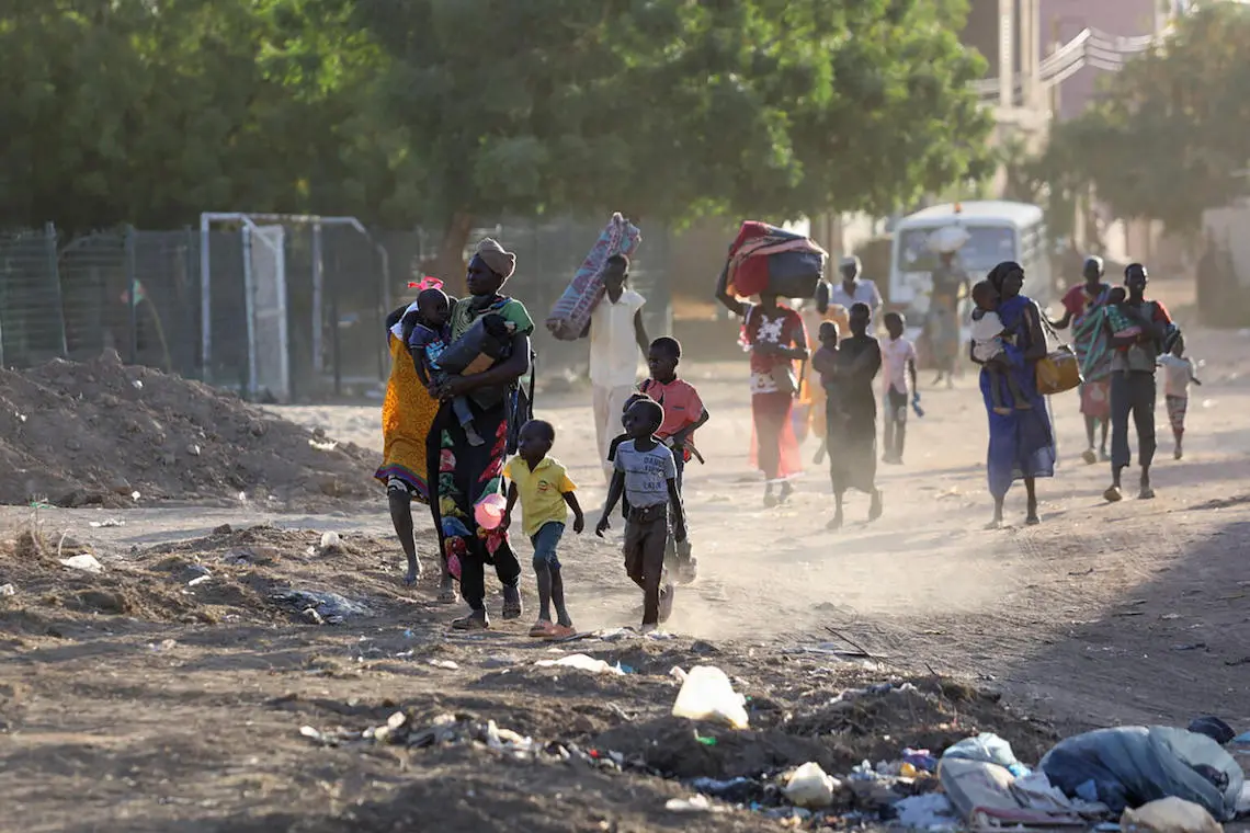 On April 19, 2023, people flee their neighborhoods amid fighting between the army and paramilitaries in Khartoum, Sudan.