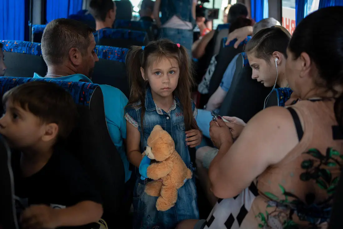 On June 7, 2023, 7-year-old Anya and her family evacuate by bus from Kherson following the collapse of the Kakhovka dam.