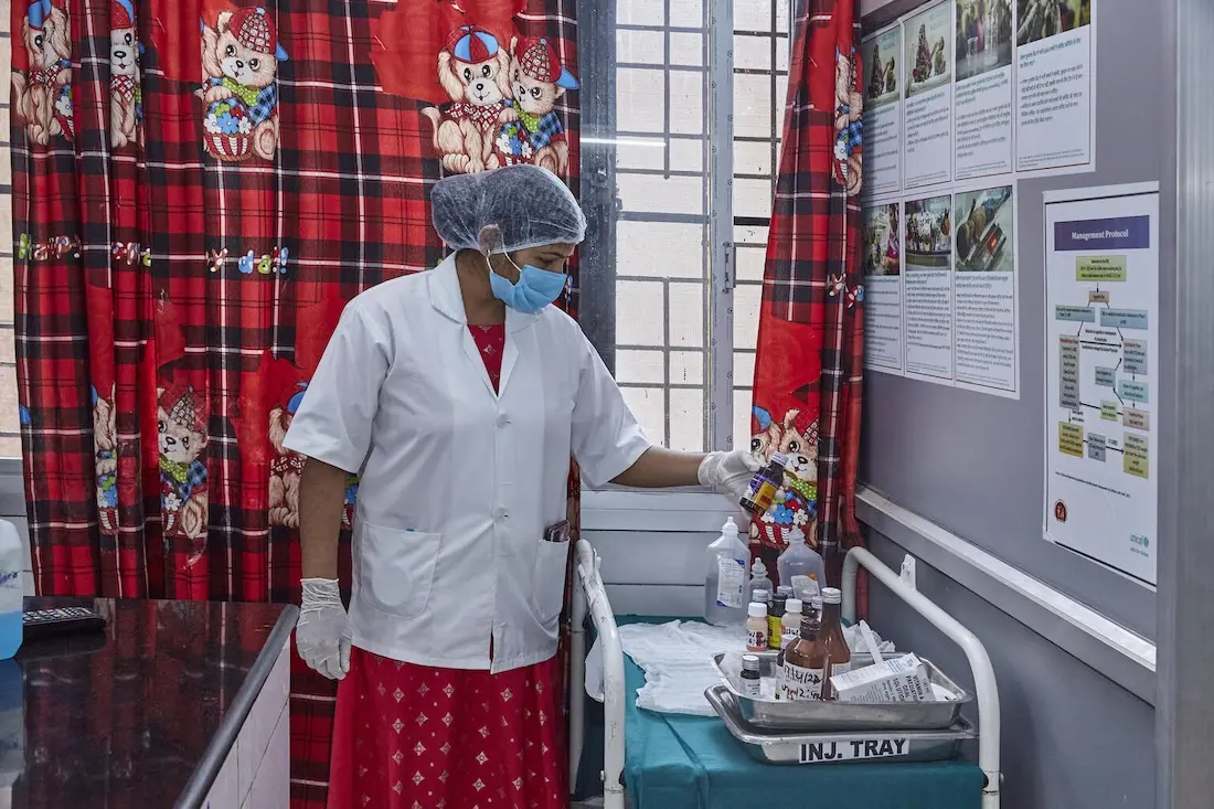 A health care worker follows compliance for labeling medicines at District Combined Hospital in Lodhi, Sonebhadra, Uttar Pradesh, India.