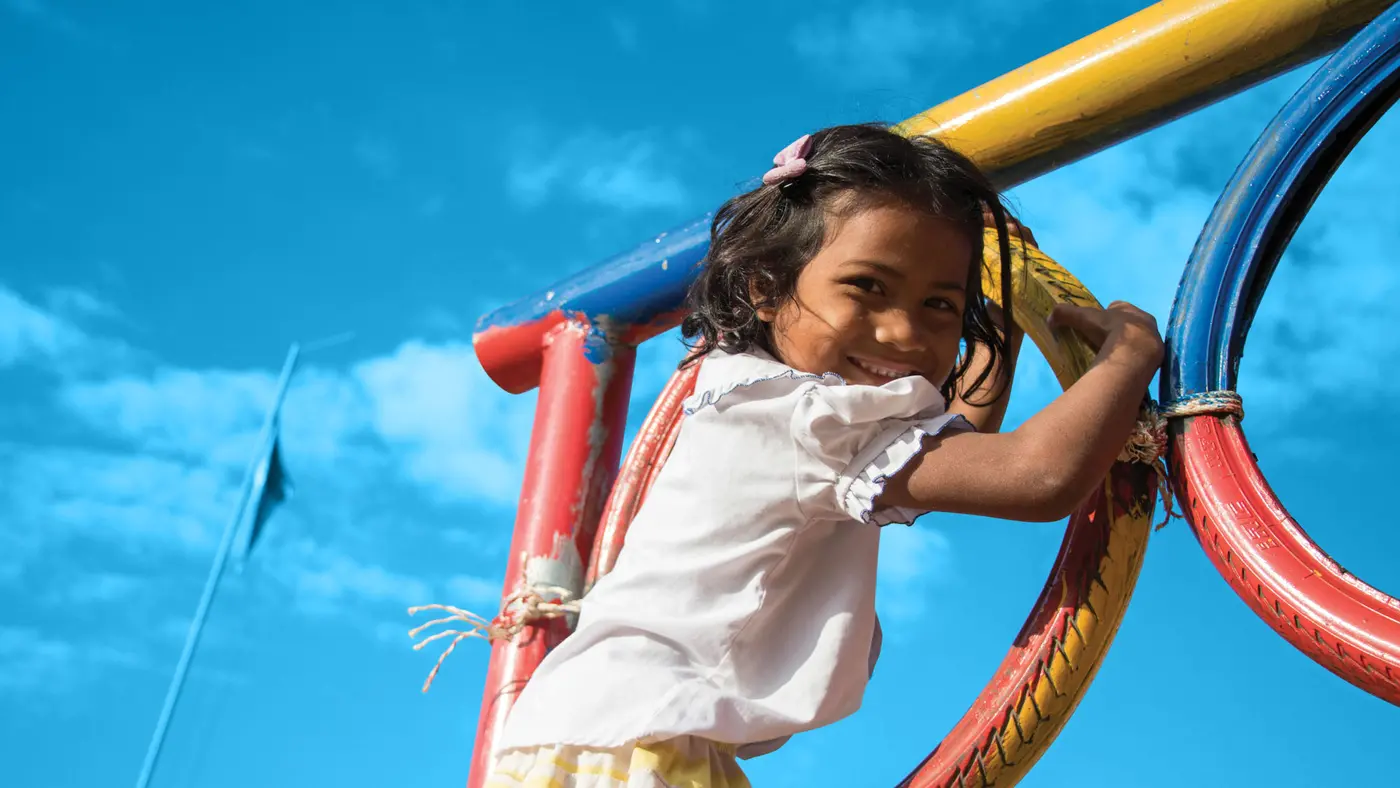 A girl enjoys playing in the playground at Srae Tahen primary school.