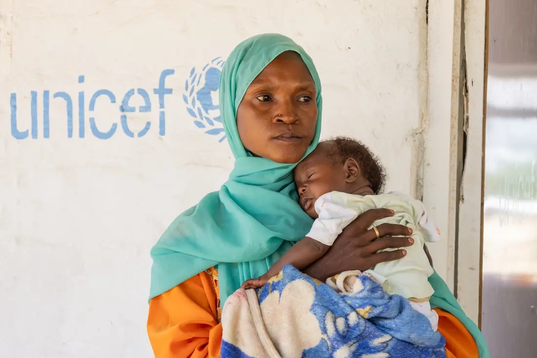 Qabil holds her 3-month-old son at the UNICEF-supported health clinic in Alkarama, Kassala state, Sudan.