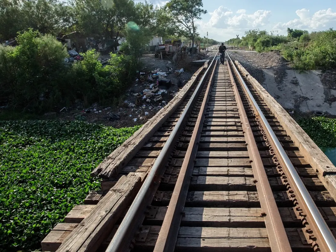 A lonely figure walks the tracks on the outskirts of Reynosa, Mexico, across the Rio Grande from McAllen, Texas.