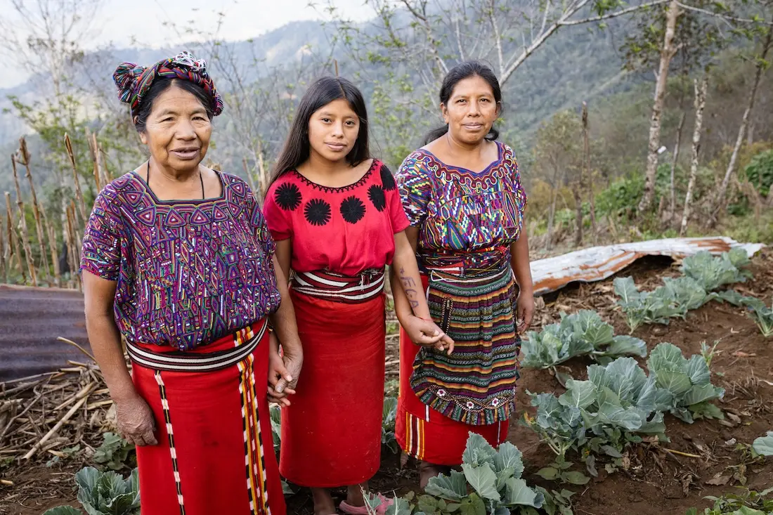 Juana Corio Raymundo, 66, with her daughter Juana Brito Corio, 38, and granddaughter Cecilia, 14, in their garden in the village of La Pista Nebaj, Quiché, Guatemala.