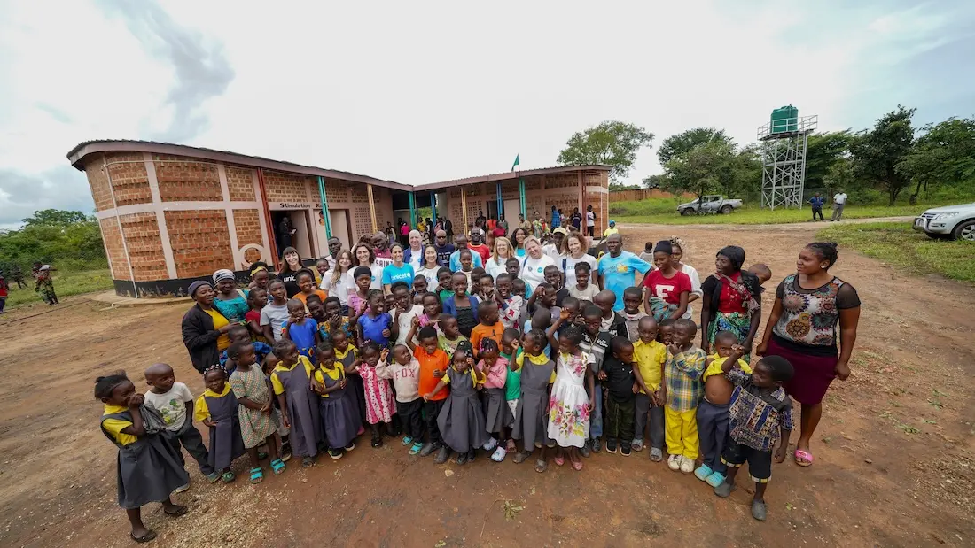 Children, caregivers, volunteers and early childhood development specialists welcome UNICEF USA staff and student Key Club International trustees at a UNICEF-supported Insaka center in Zambia.