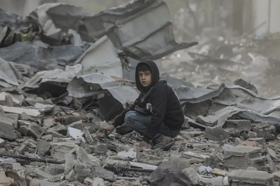 Ten-year-old Qusay searches in the wreckage of his home in in the Al-Touam area in the northern Gaza Strip.