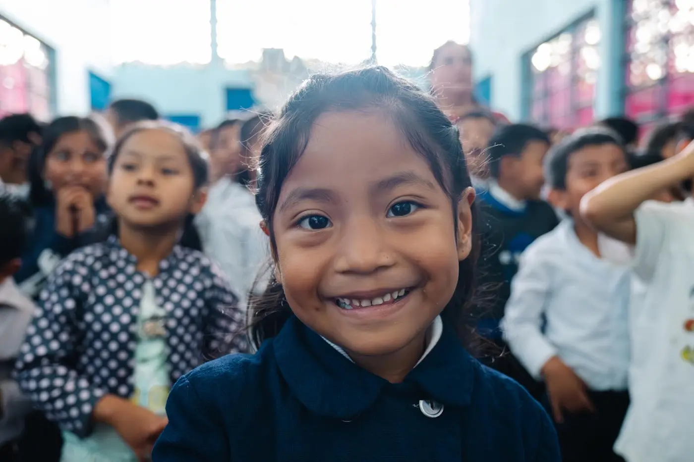 A girl in Guatemala smiles while learning at a UNICEF sanitation event