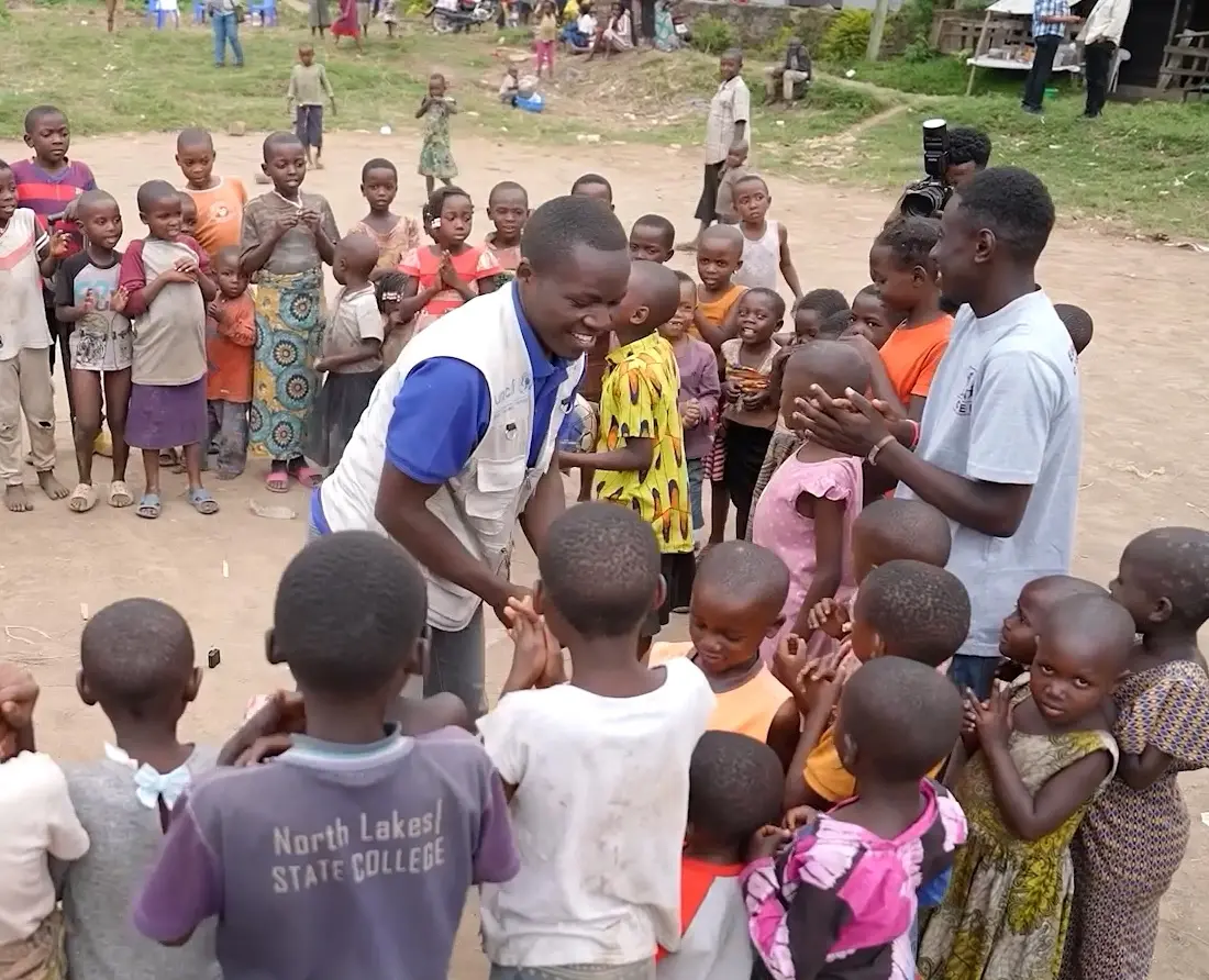 Bienfait, community social worker in North Kivu, DRC, with children he supports.