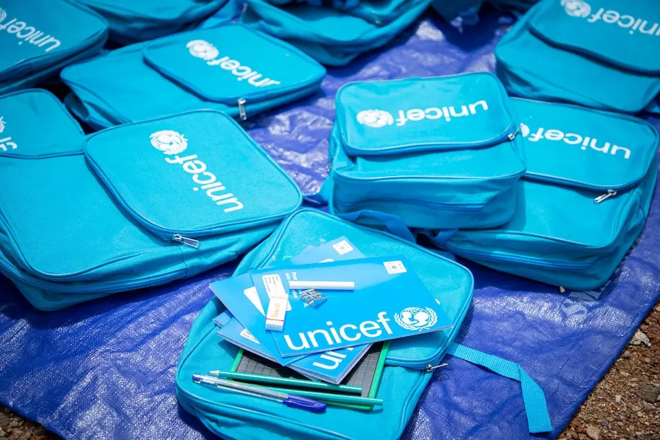 At a UNICEF warehouse, UNICEF school kits are prepared for delivery to children..