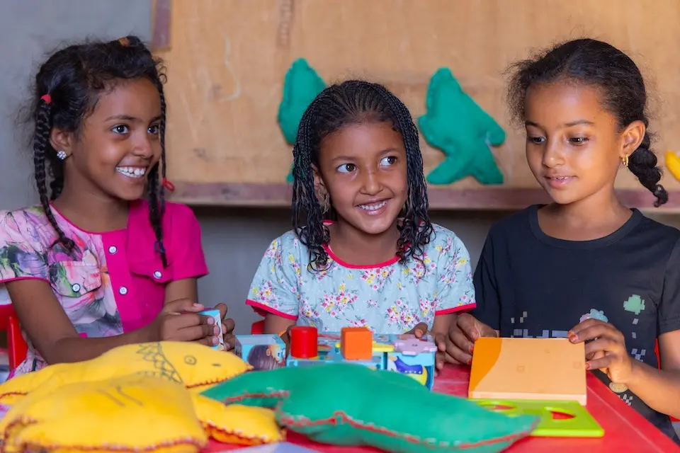 Three girls sit in a UNICEF-supported classroom in Rachid village, central Mauritania.