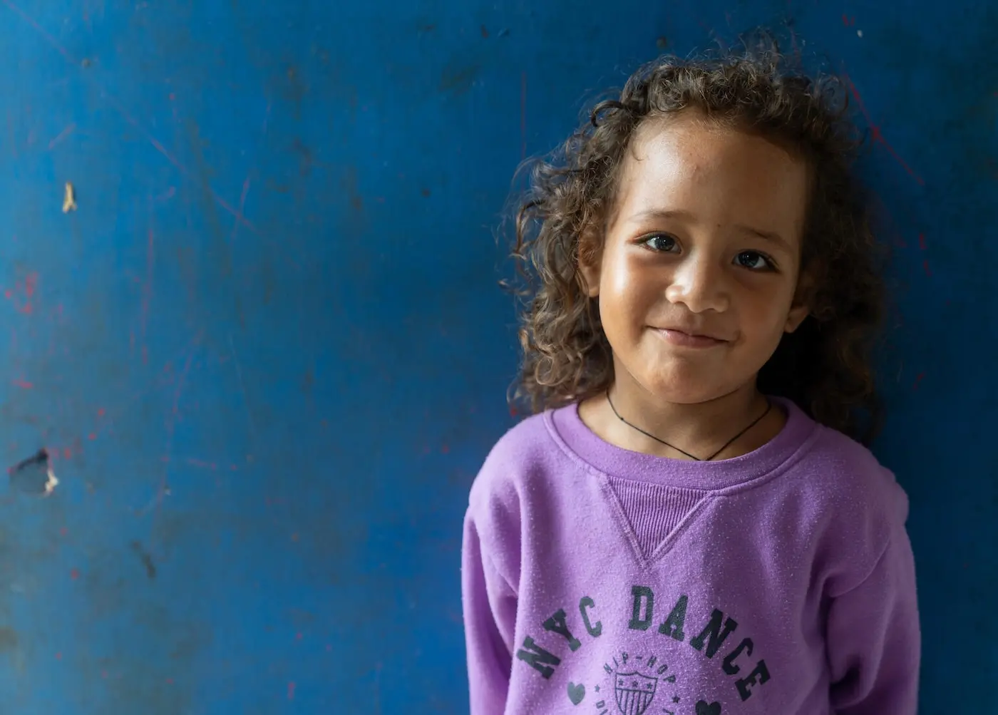 A girl stands in her home in Ha’api, Tonga