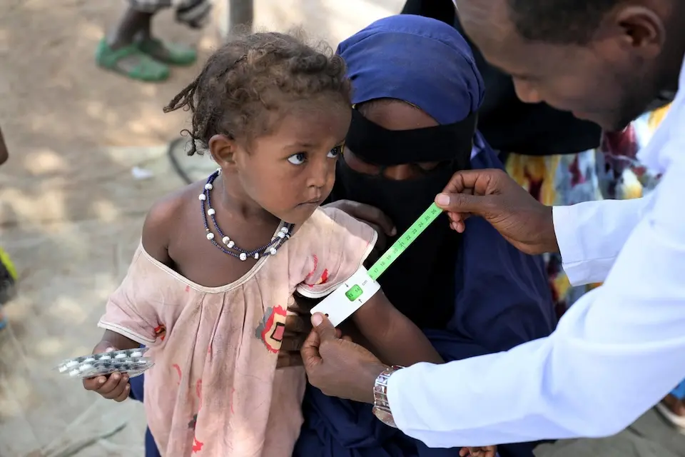A young girl is screened for malnutrition by a UNICEF-supported nutrition worker in Afar, Ethiopia.