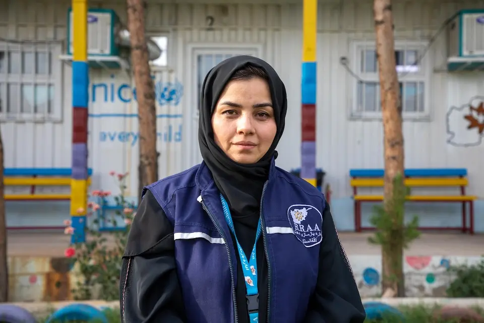 A UNICEF-supported social worker stands in front of her place of work at Guzara Transit Center in Herat Province, Afghanistan.