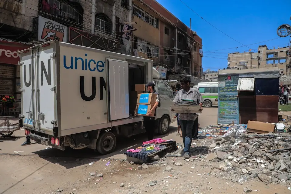 Boxes of diapers are unloaded from a UNICEF truck for delivery to the neonatal intensive care unit of the Friends of the Patient Society Hospital in Gaza City on July 30, 2025.