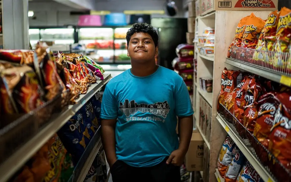 G'okie, 14, stands inside a grocery store in downtown Kolonia, in Pohnpei, Federated States of Micronesia. 