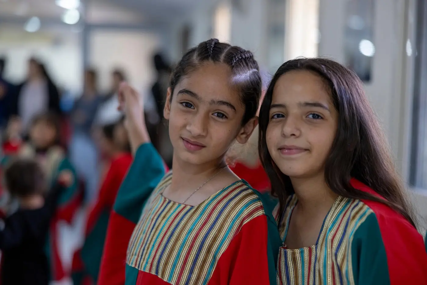 Two girls enjoy a UNICEF open day in Palestine, where 1,200 children from hotspot areas came together to learn, play and connect.