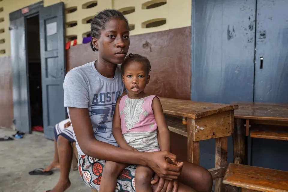 In Haiti, Naika Bienvil, 21, and her 2-year-old daughter take refuge in a school converted into a shelter as Hurricane Melissa approaches.