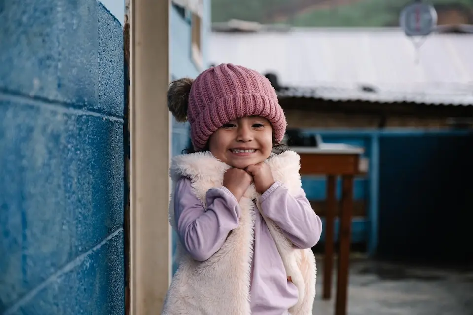 On March 17, 2025 in Chiretzaaj, Cobán, Guatemala, 3-year-old Amani smiles outside the local health center.