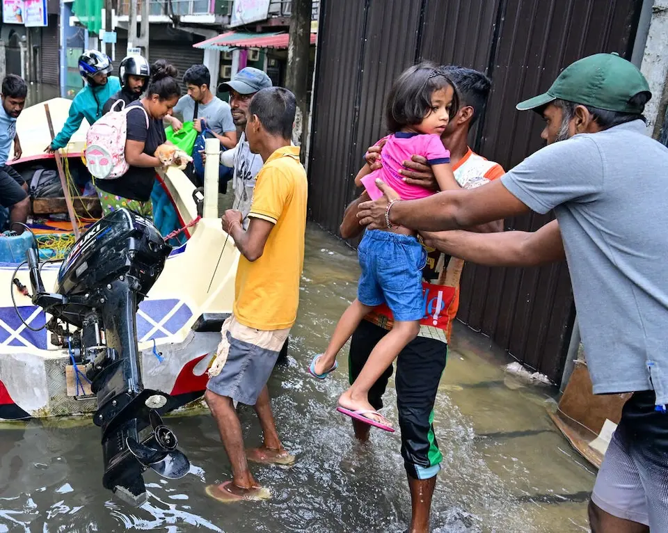 Residents evacuate to escape flooding in Wellampitiya, outside Colombo, Sri Lanka, on Nov. 29, 2025.