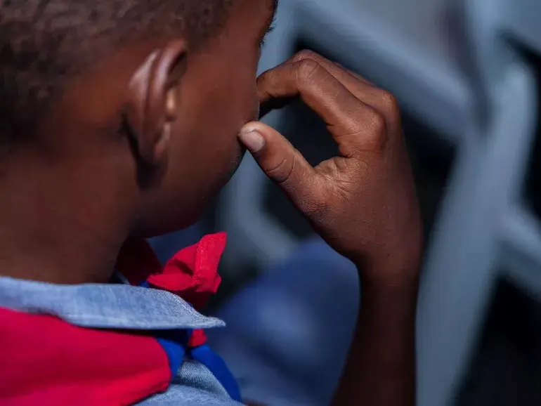 A young boy at a transit center in Haiti helping children recruited by armed groups recover and reintegrate.