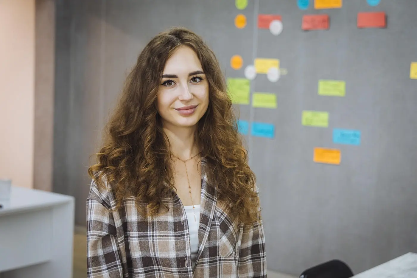 A girl in Ukraine smiles during her internship, supported by UNICEF, to help young women try out careers and build confidence