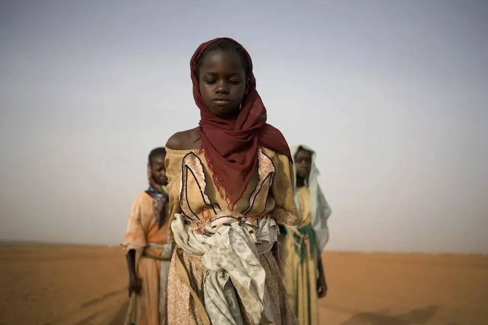 A UNICEF archival image of girls leaving a displacement camp to gather firewood in Darfur, Sudan, in 2005.
