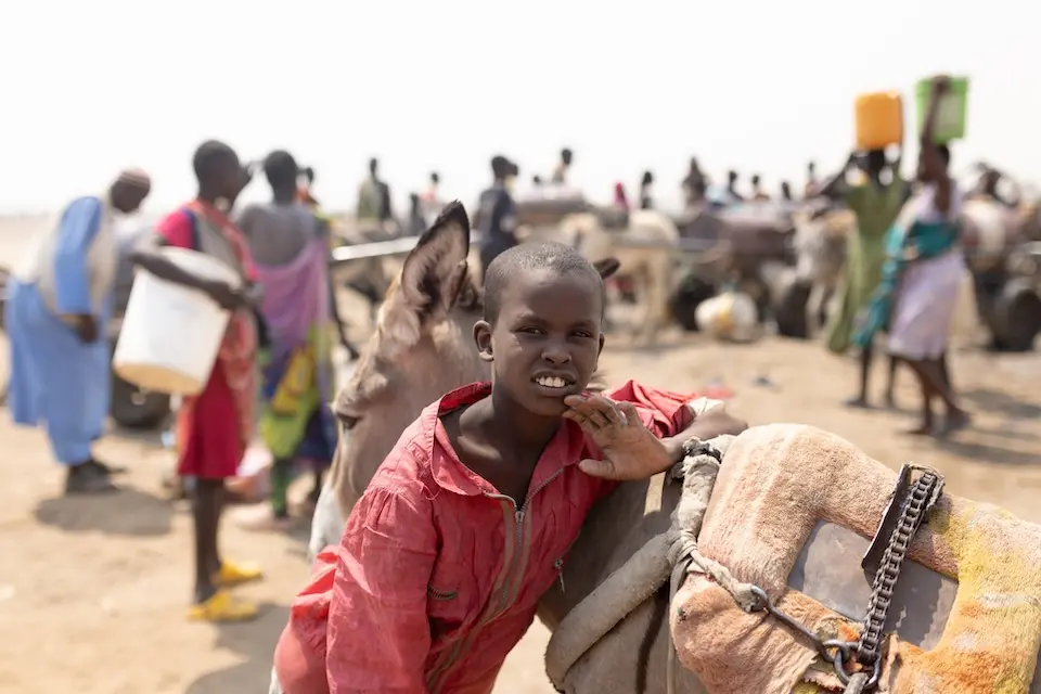 Malik, 10, arrives at a water point in White Nile State, Sudan.