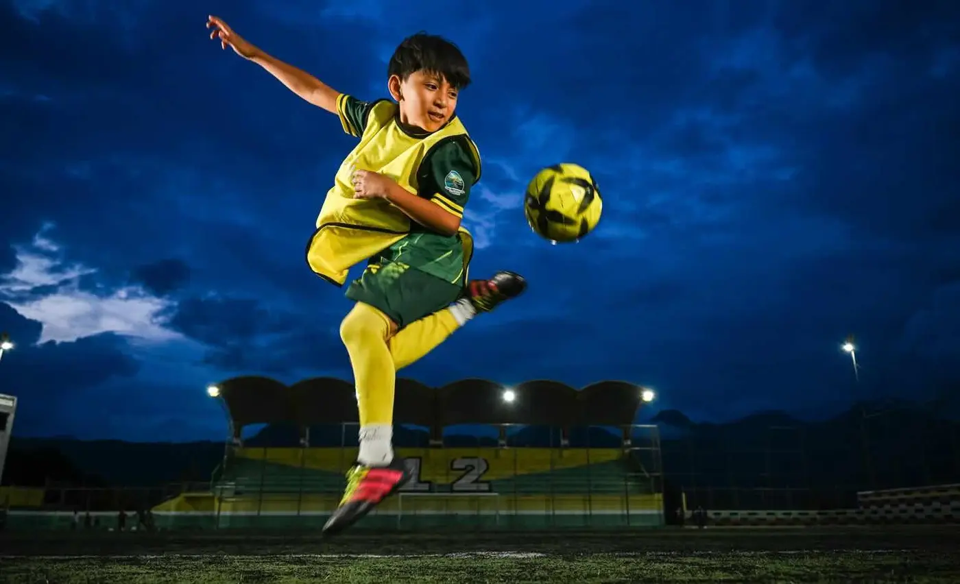 Young boy plays soccer in Guatemala as a member of the UNICEF-supported, Fair Play program