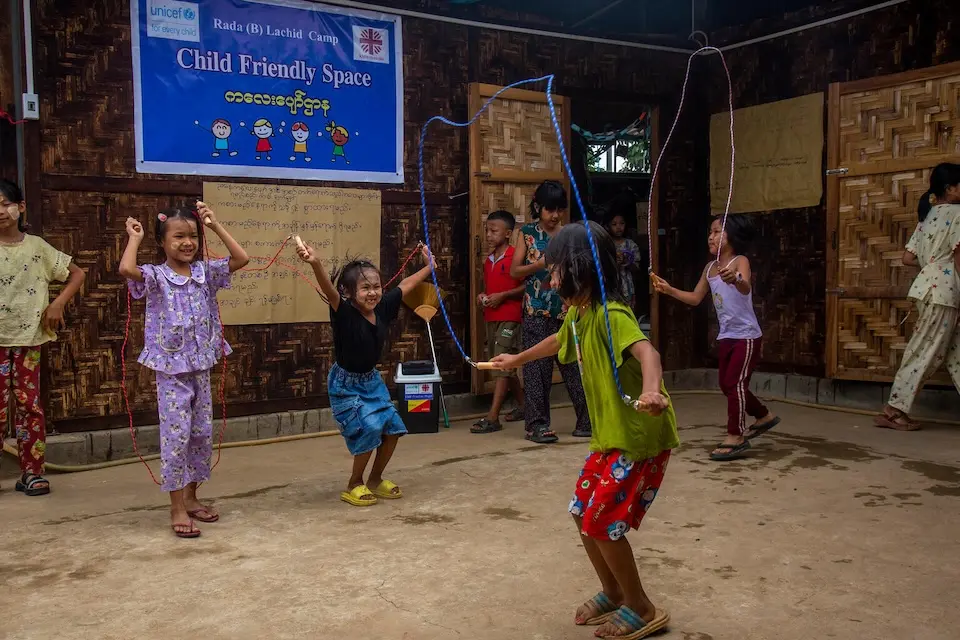 Girls jump rope in a child-friendly space in Myanmar.