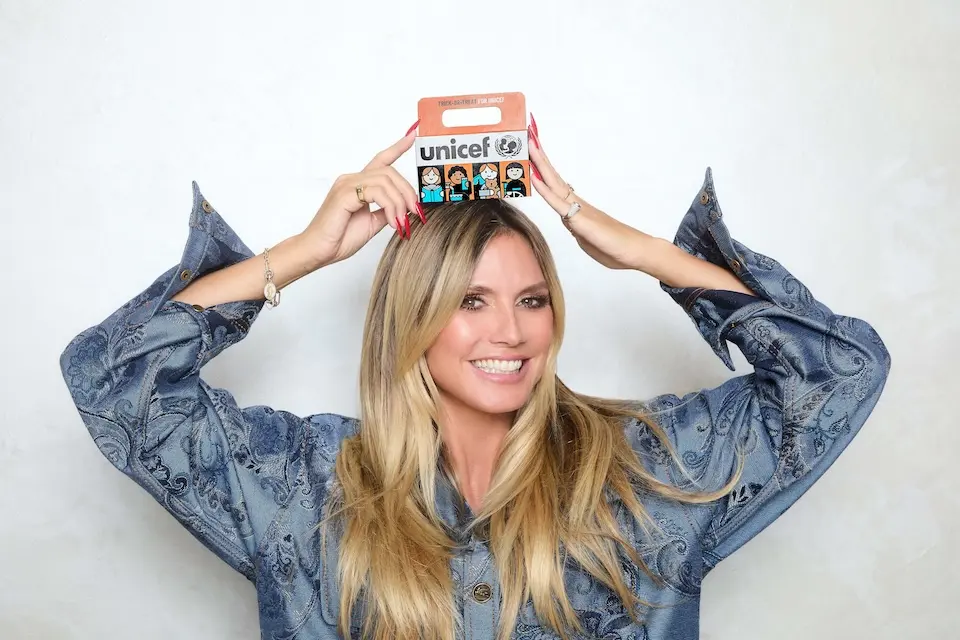 UNICEF Ambassador Heidi Klum holds a Trick or Treat for UNICEF box.