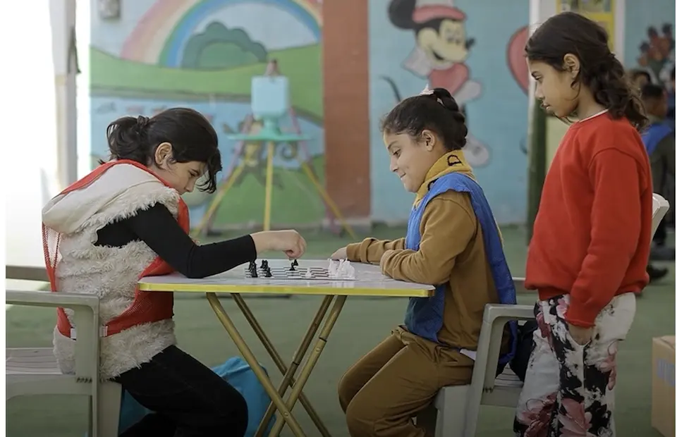 Children play chess at a UNICEF-supported child-friendly space in Lebanon.