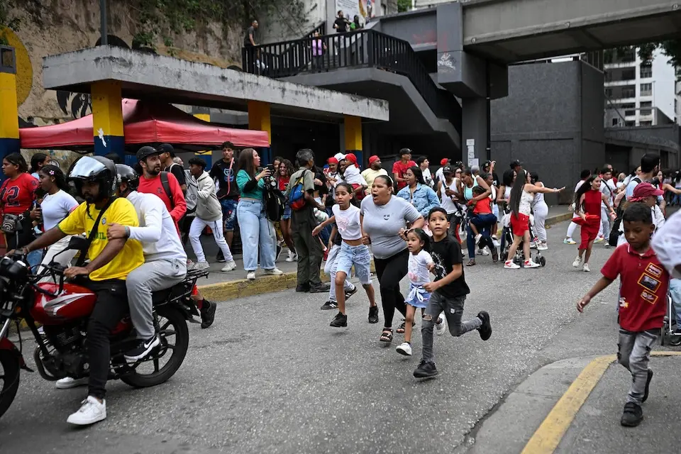People run into a street following an earthquake in Caracas on June 24, 2026.