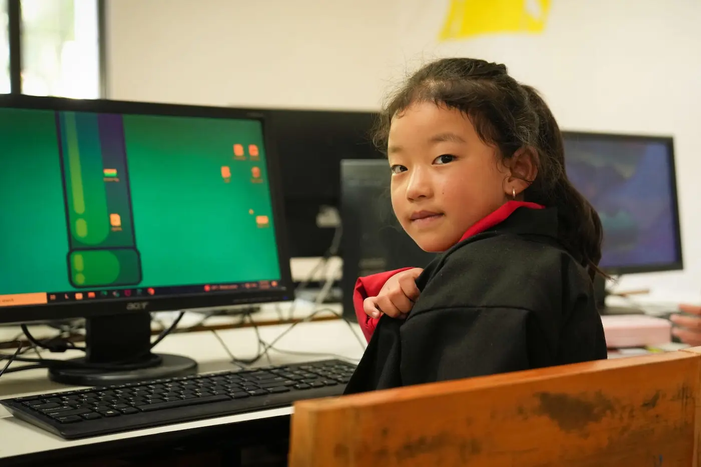 A 7-year-old girl in Bhutan learns coding in a computer lab through a UNICEF program