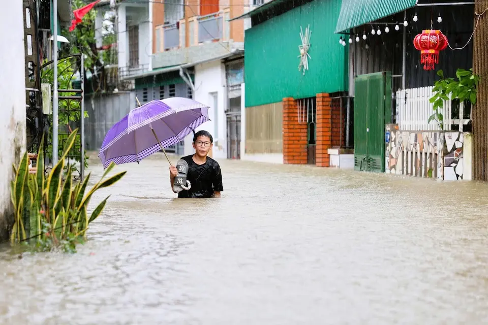 Trung Thanh, 15, in floodwaters that engulfed Vinh City and other Vietnam communities after 2025 Tropical Storm Bualoi.