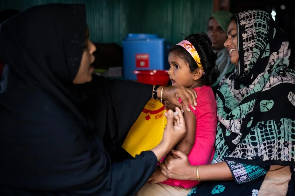 Four-year-old girl in Bangladesh receives a typhoid vaccine.