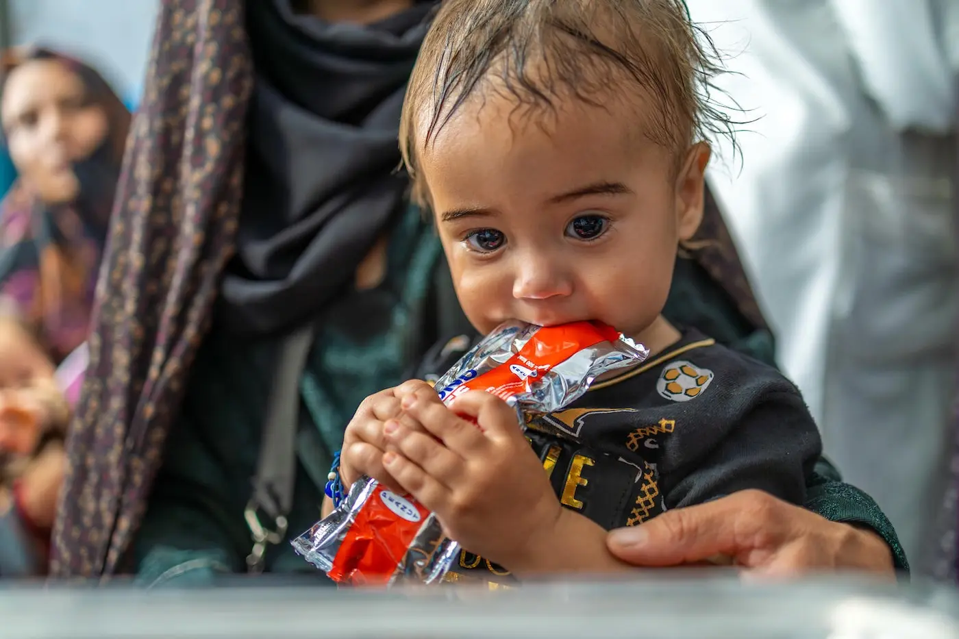 Aref, a one-year-old from Herat, Afghanistan, is undergoing a health and nutrition assessment and receiving a further supply of ready-to-use therapeutic food (RUTF) from UNICEF to treat malnutrition. 