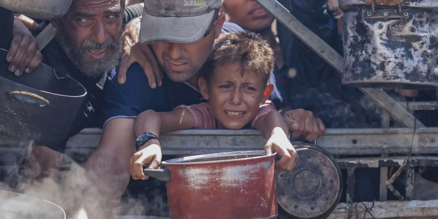 Sad child holding a pot, waiting for water 