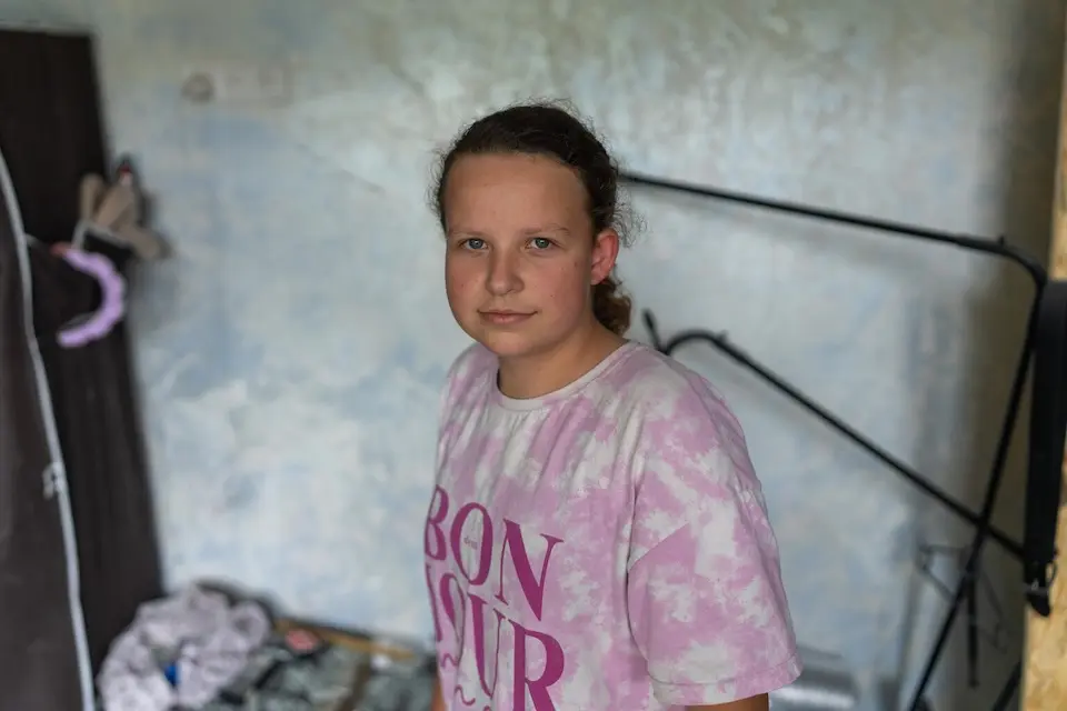 On Sept. 1, 2026, Sofiia, 14, stands in her family's apartment, damaged in an overnight attack in Boryspil, Kyiv region, Ukraine.