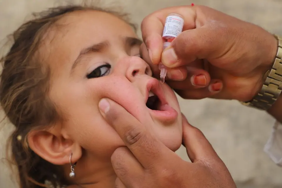 A girl receives the oral polio vaccine in Kandahar, Afghanistan.